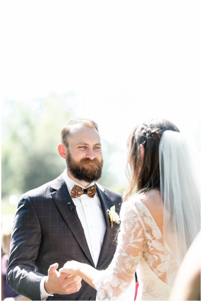 The Best Boise Wedding Photographers, Denise and Bryan Photography. Duck feather bow tie wedding groom. Groom smiling crying at bride